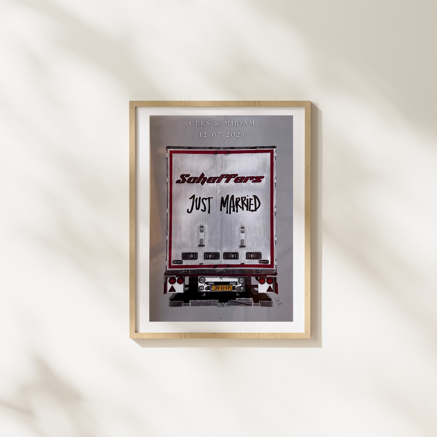Framed artwork with 'Just Married' text and a car design on a white wall.