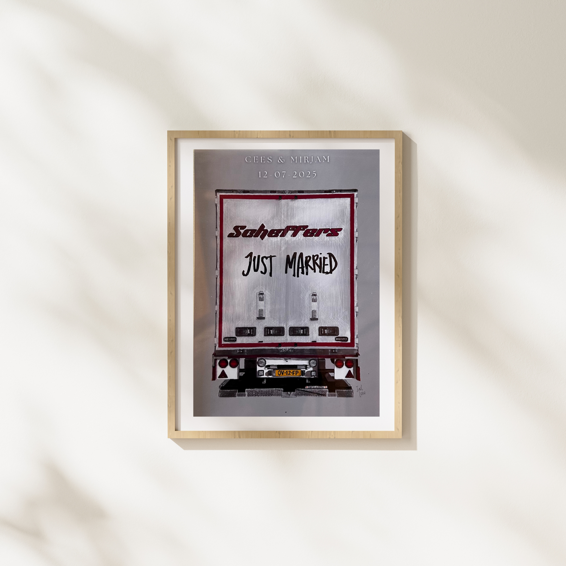 Framed artwork with 'Just Married' text and a car design on a white wall.